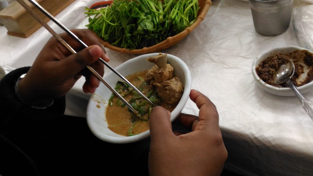 You serve yourself and into a small dish to eat. I used my hands but most people use chop sticks.