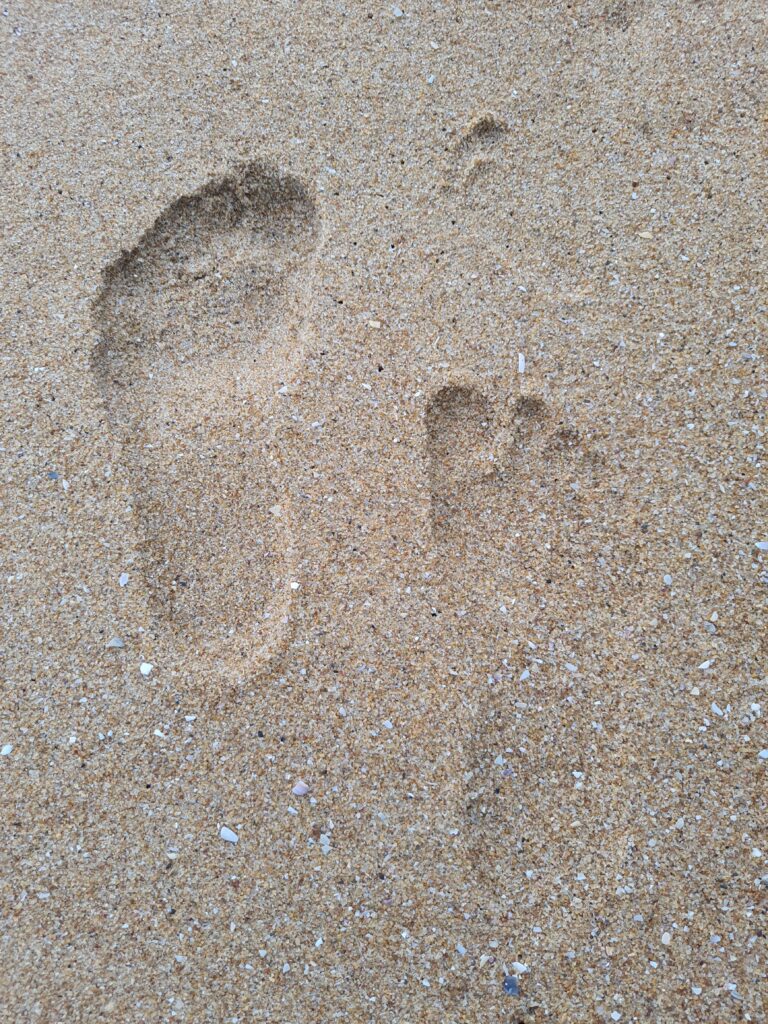 Footprints of Anju, Thej and Uma. Uma's first visit to beach.