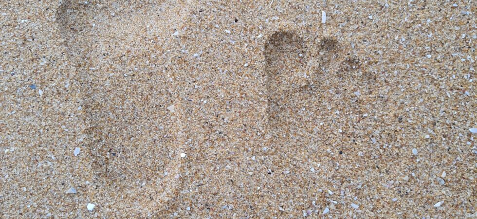 Footprints of Anju, Thej and Uma. Uma's first visit to beach.