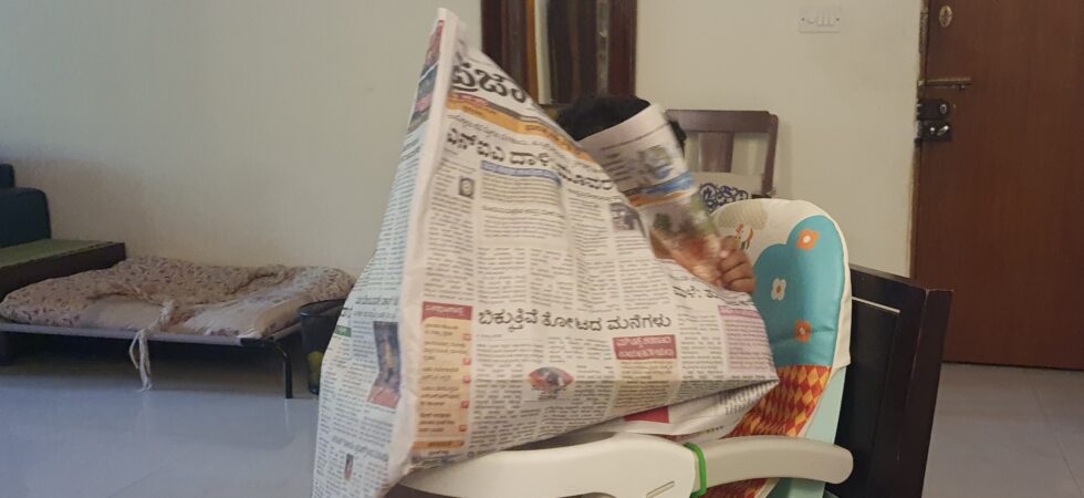 Uma imitates my newspaper reading style.